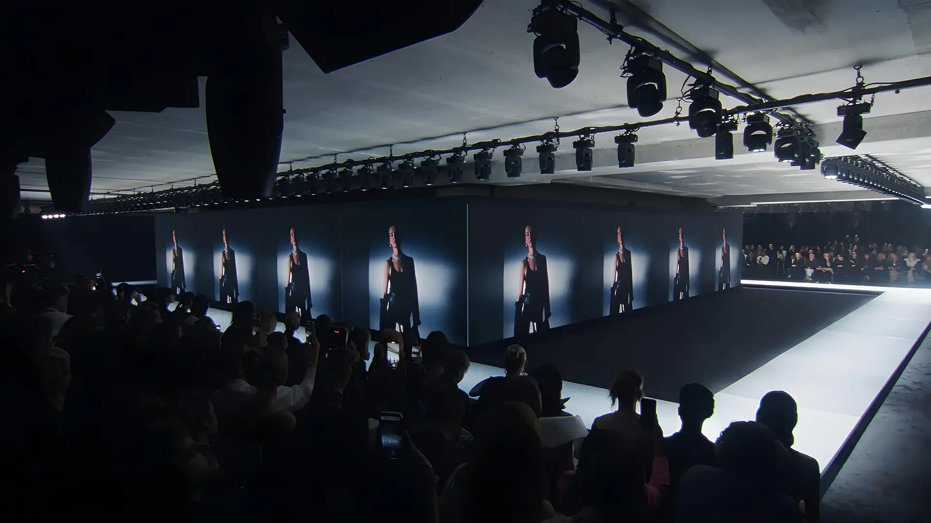 Runway photo, brand video playing on screen
