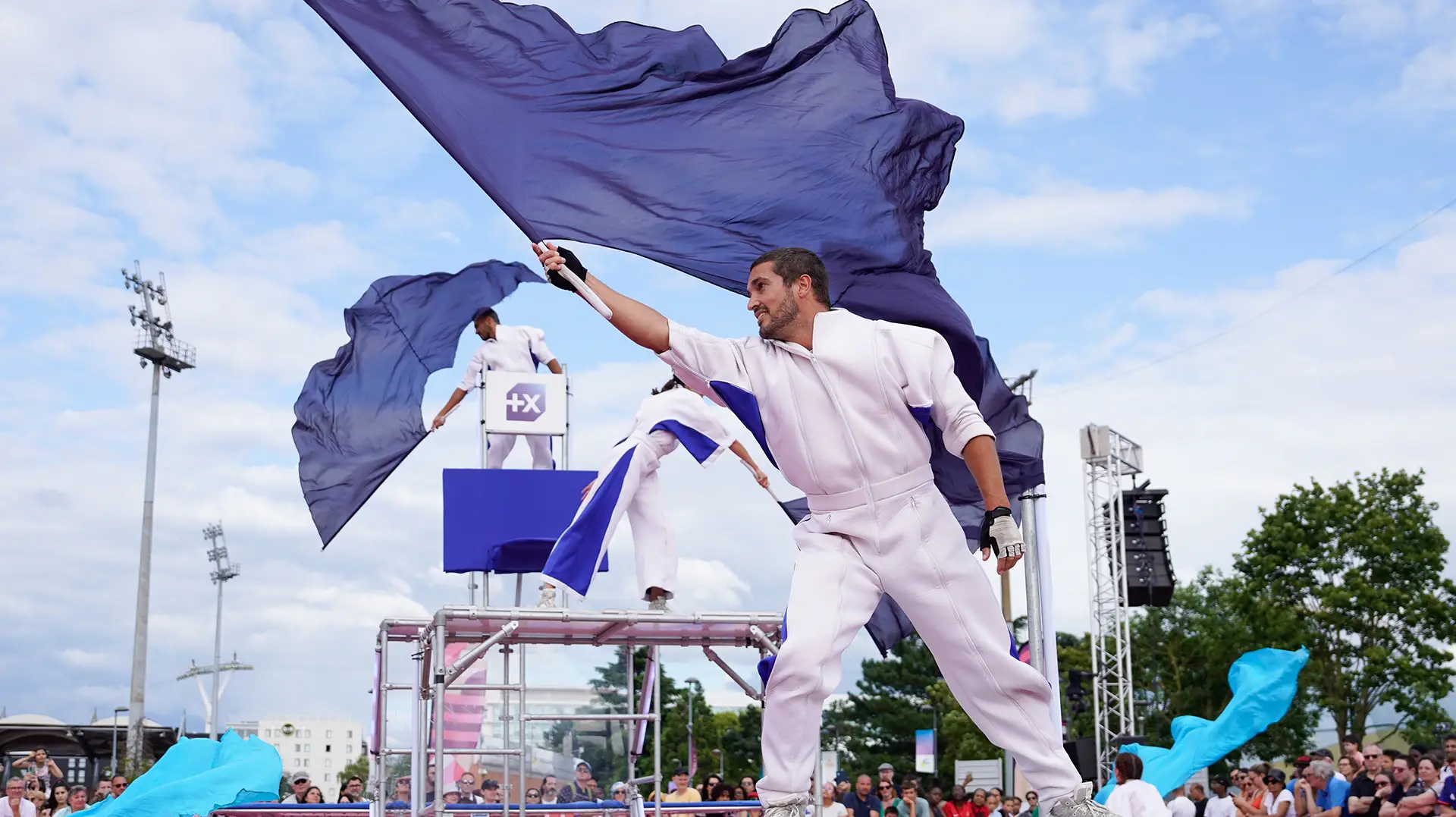Performers waving flags of the Banque Populaire