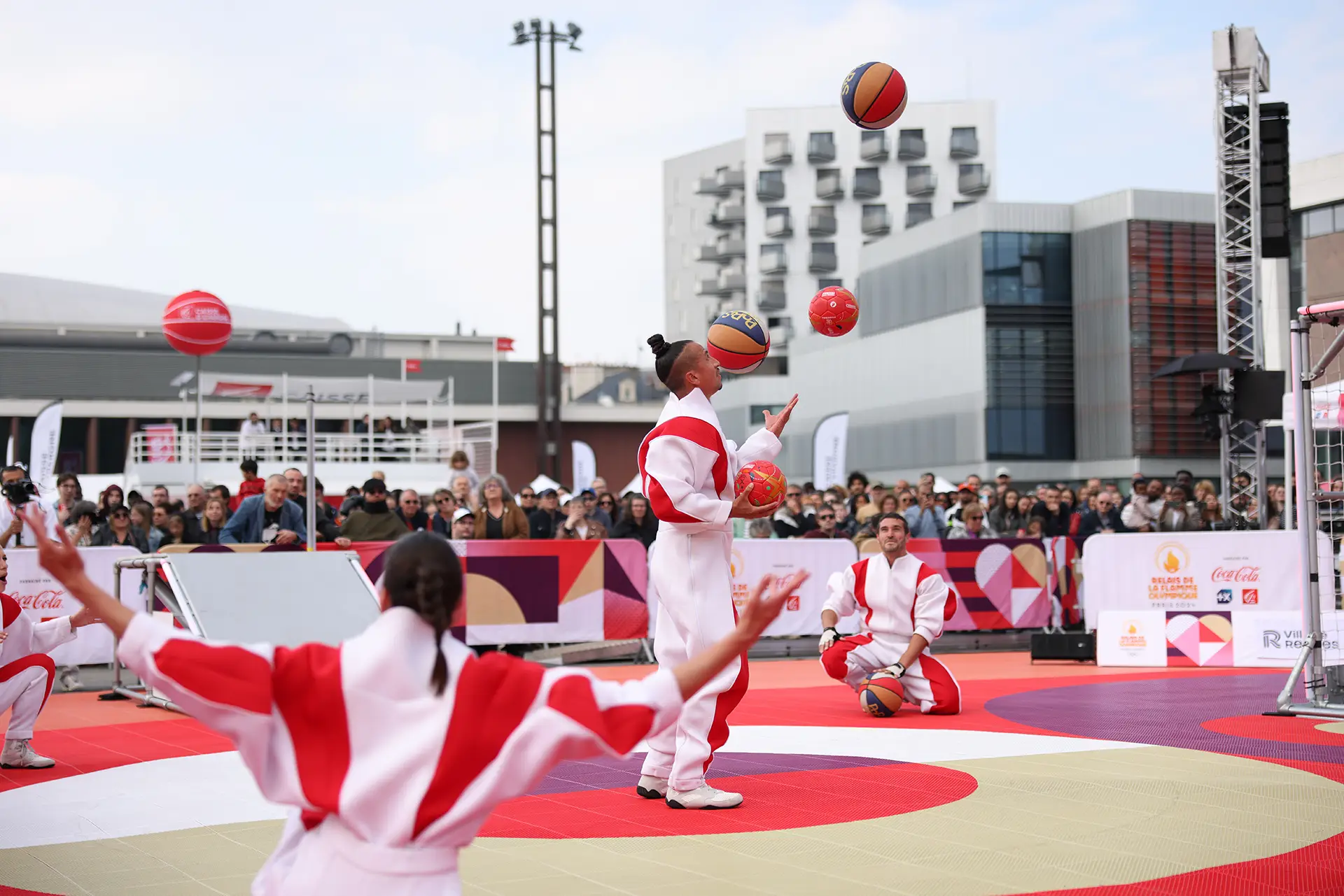 Performers playing with basketballs during an activation for Caisse d'Épargne