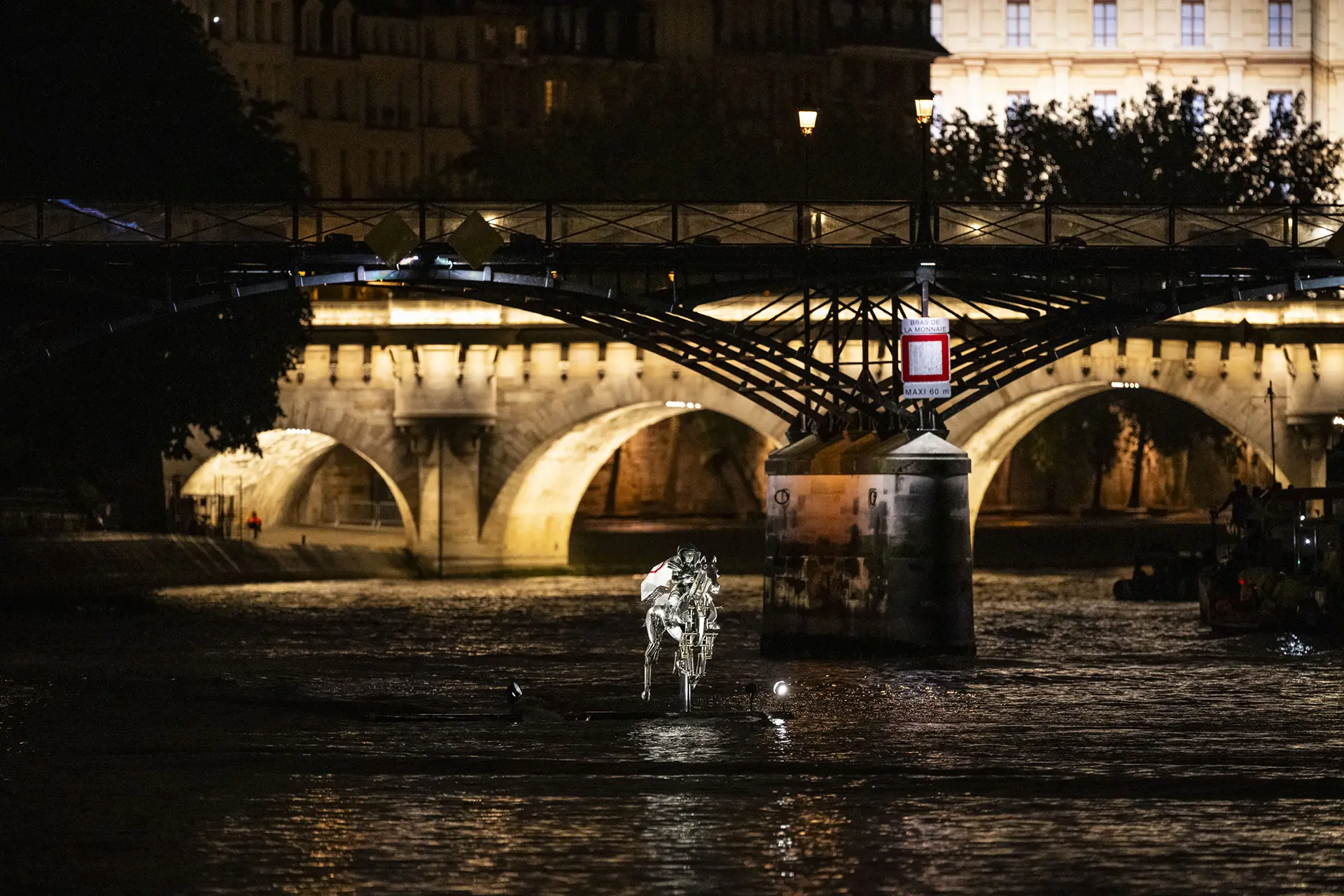 Silver rider on a metallic horse over the seine, during the Opening Ceremony of PARIS 2024 Olympic Games