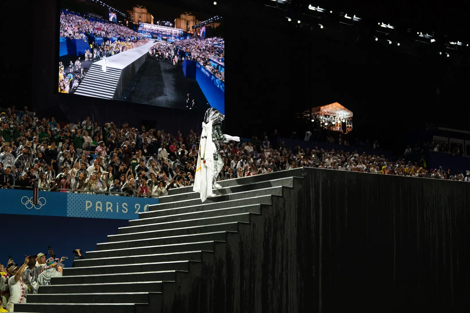 Silver rider bringing the olympic flag on the main stage in the Trocadéro
