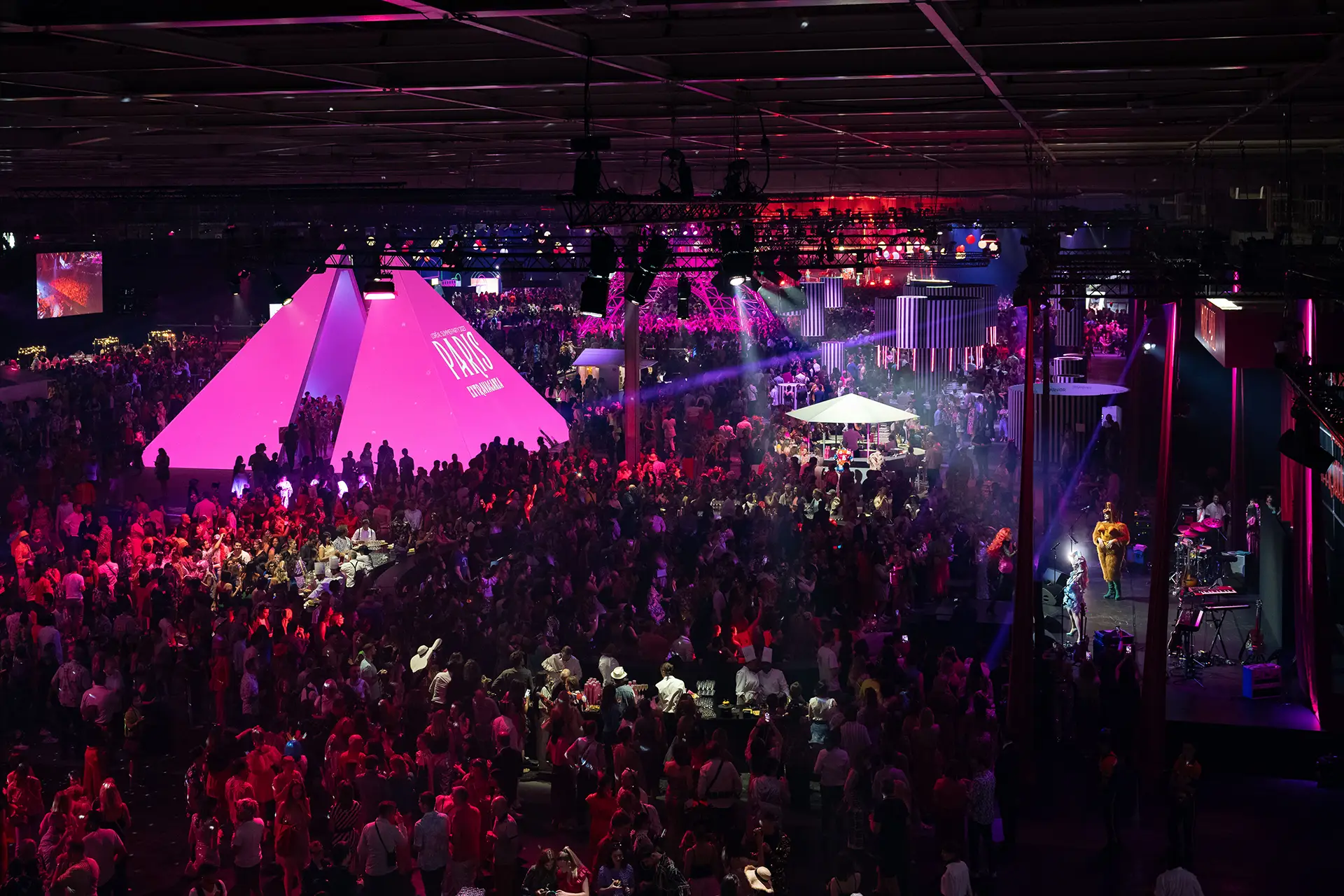 Iconic elements of Paris recreated inside the venue in a pink style: Eiffel Tower, Louvre Pyramids, etc.