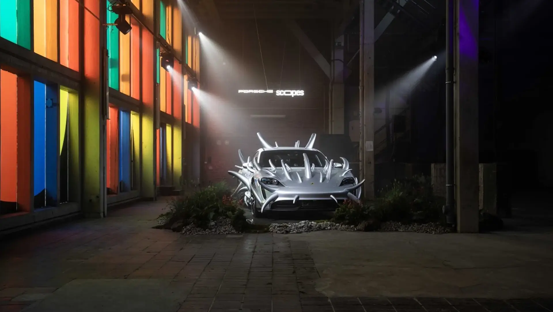 Artistic installation featuring a spiky Porsche Taycan at the SCOPES festival
