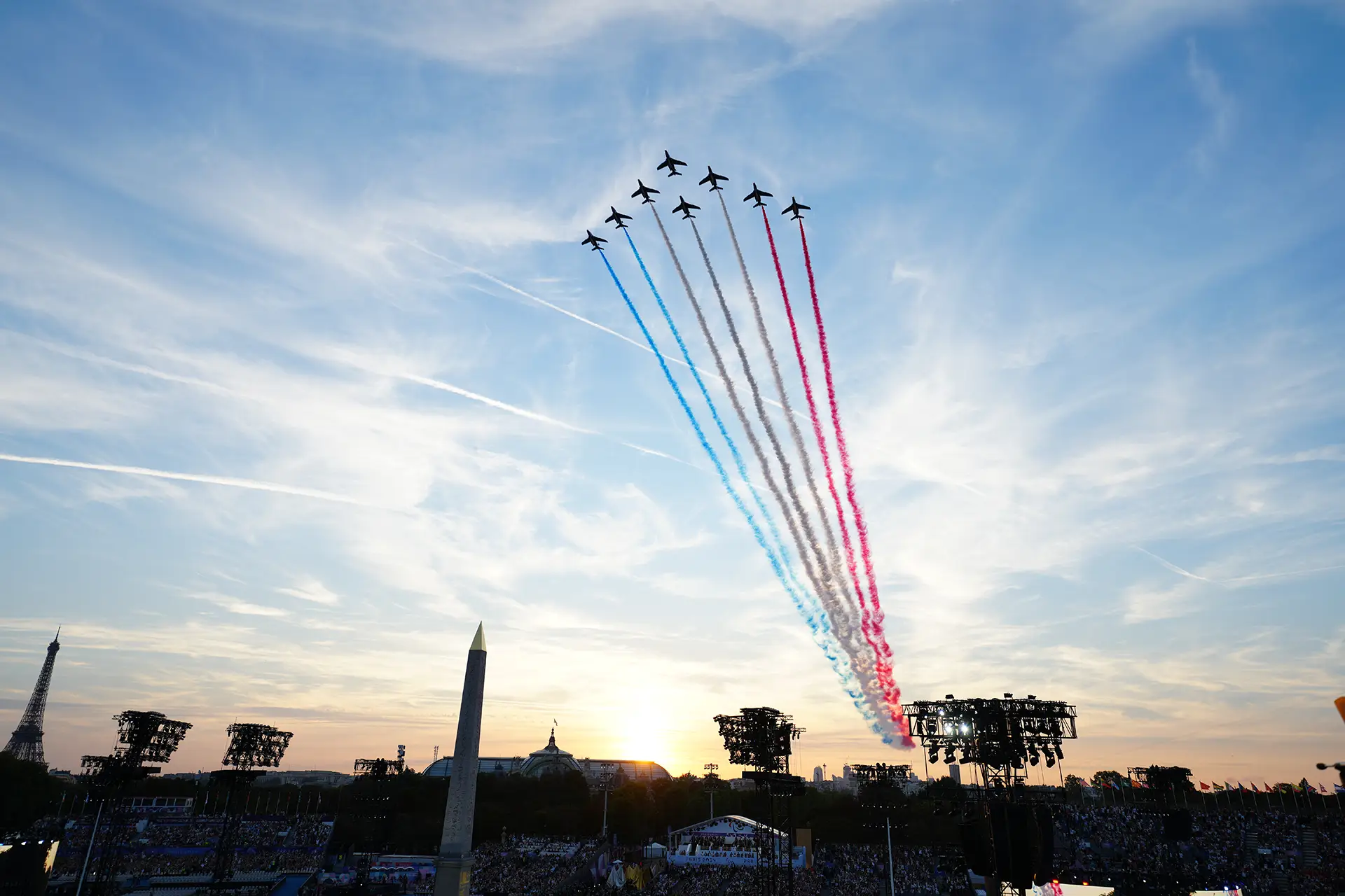 Eight planes leaving blue, white and red smoke in the sky of Paris