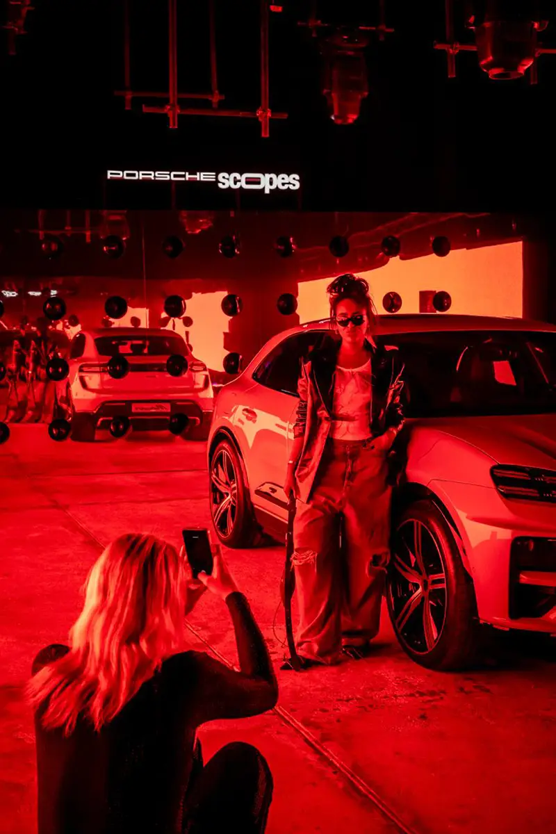 Guests and content creators taking pictures with the cars on display