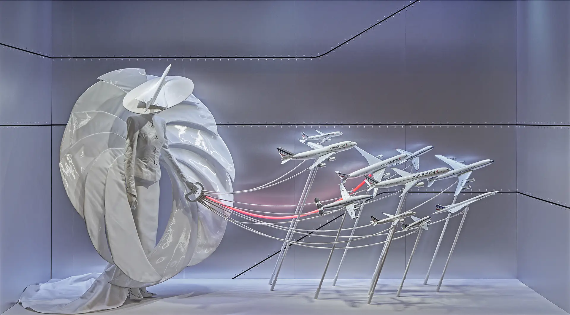 Majestic custom made dress in the Galeries Lafayette windows in Paris, various Air France planes on a leash, it looks like the model is walking the planes like they are dogs