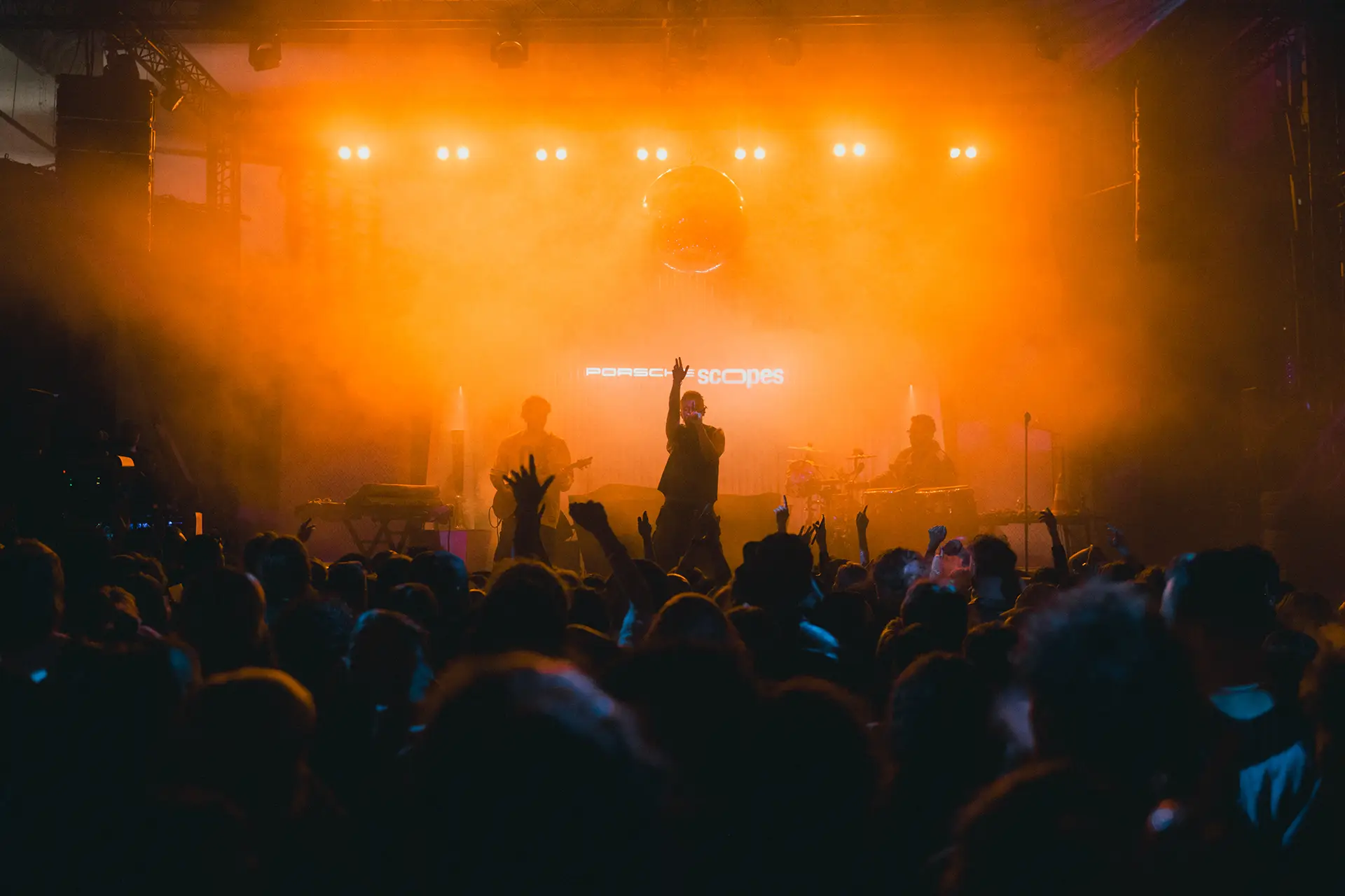 Photo of the party, orange light, band playing on stage