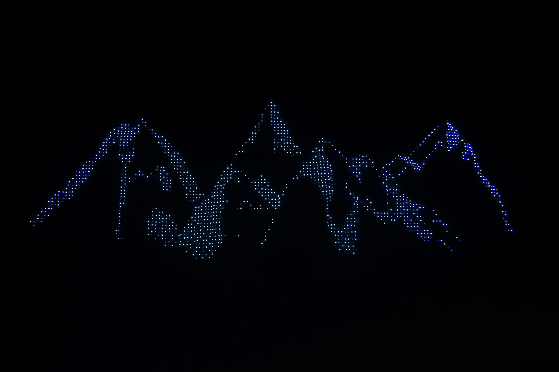 Drone show creating snowy mountains in the sky