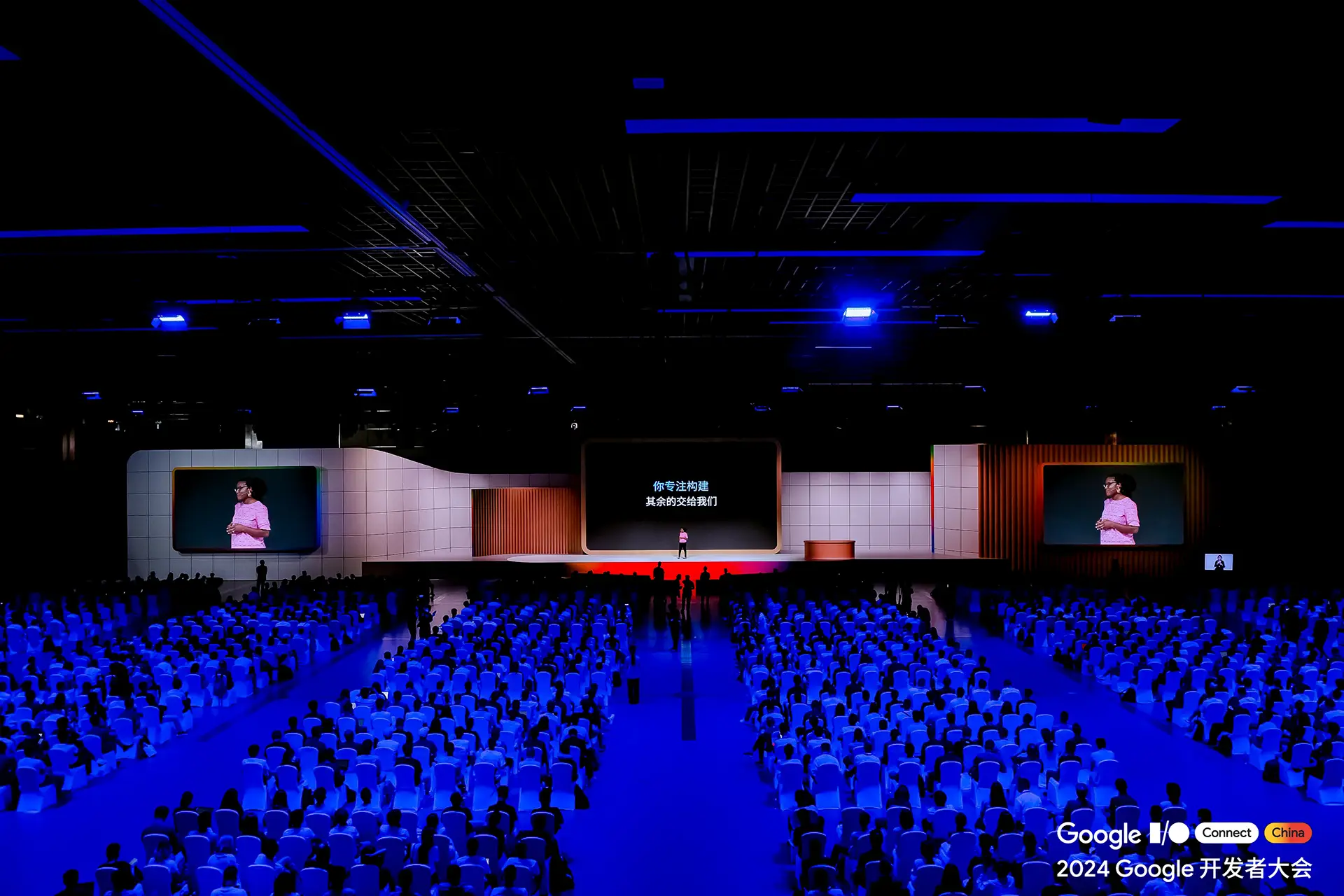Wide stage, giant presentation screen in the middle, and two spare giant screens on the side to feature the speaker