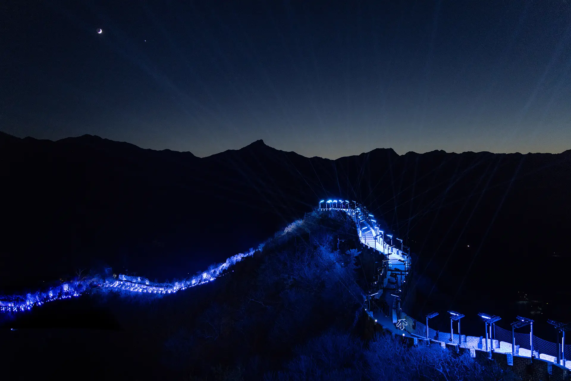 Another wide shot of the great wall, mountain skyline at dusk