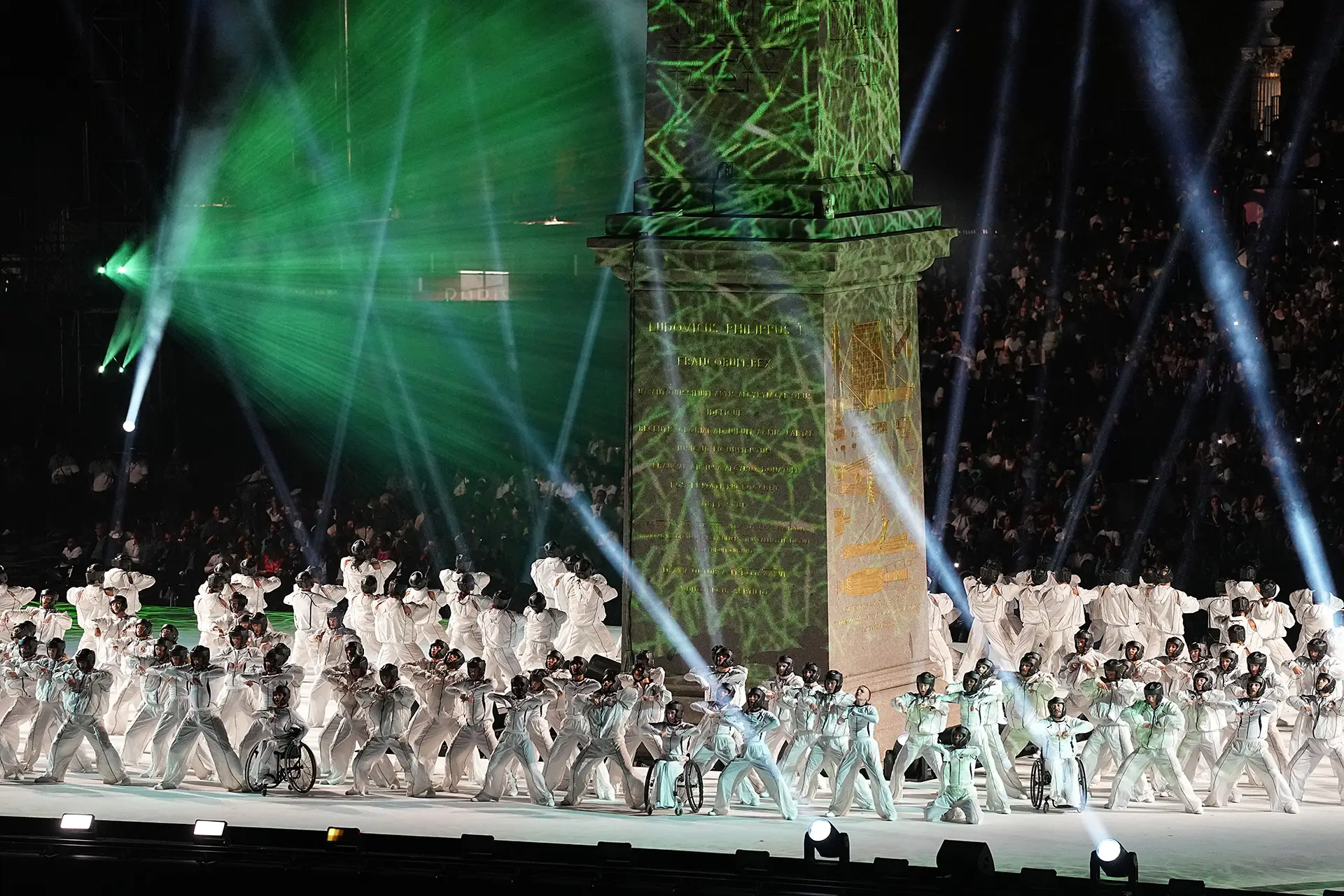 Dancers in white suits near the obelisk