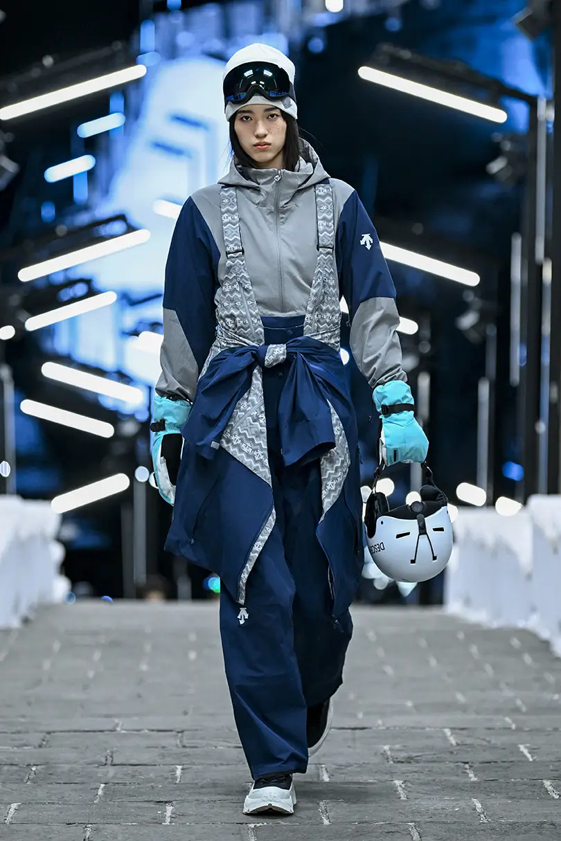 Model wearing grey and blue winter sportswear