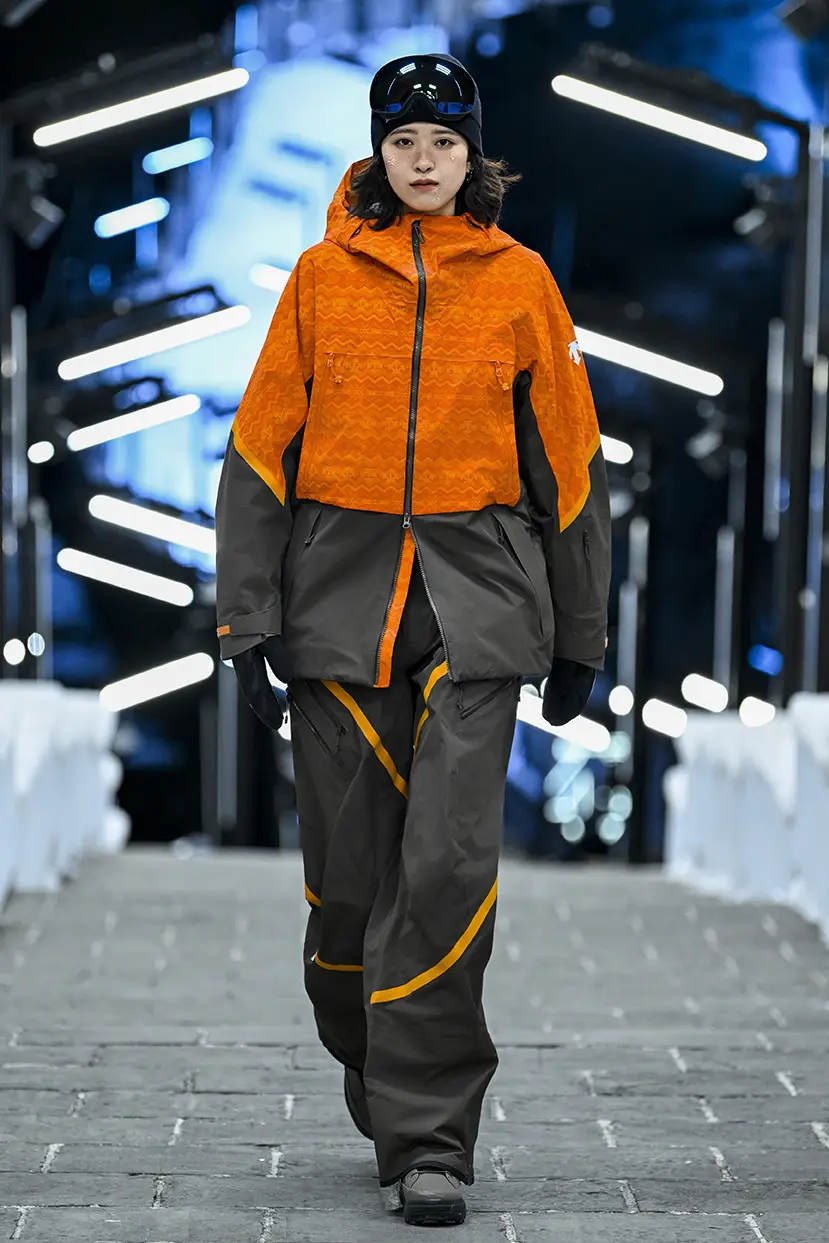 Model wearing orange winter sportswear