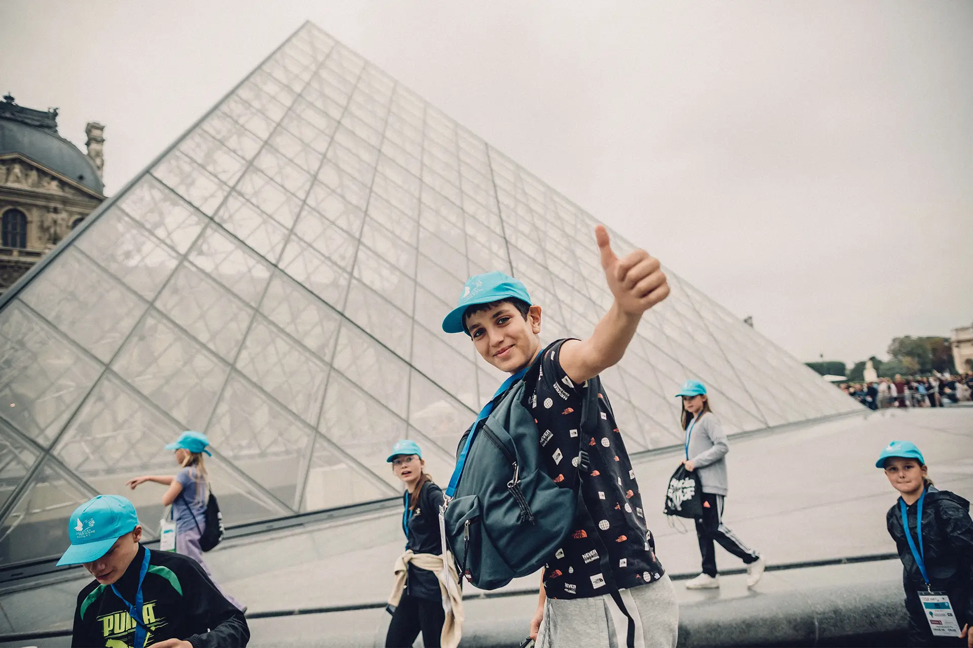 Children in front of the Louvre pyramid in Paris
