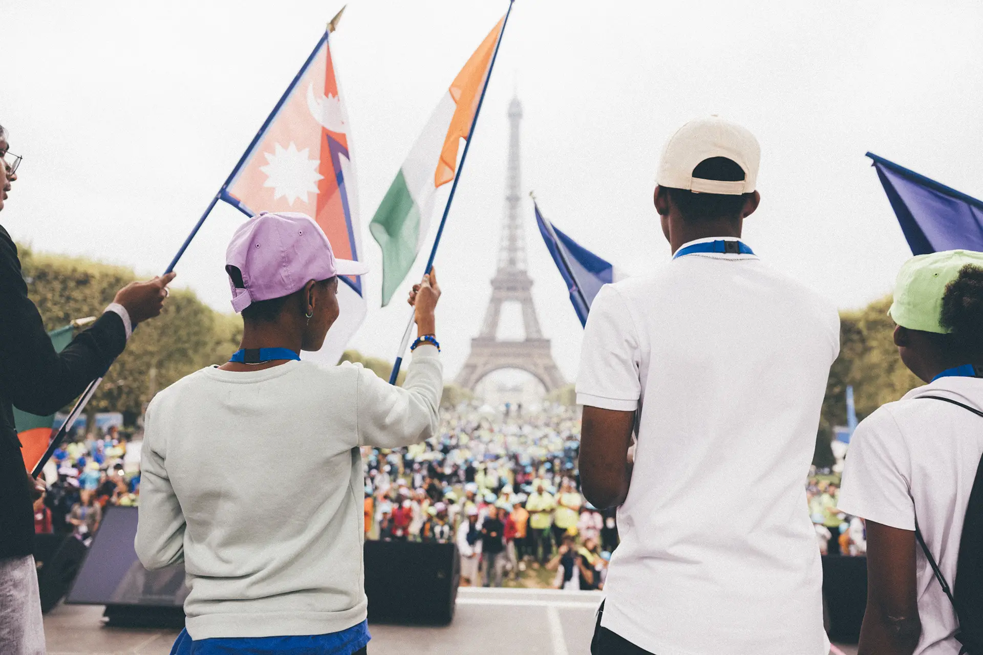 Children from different continent bearing the flag of their country on stage