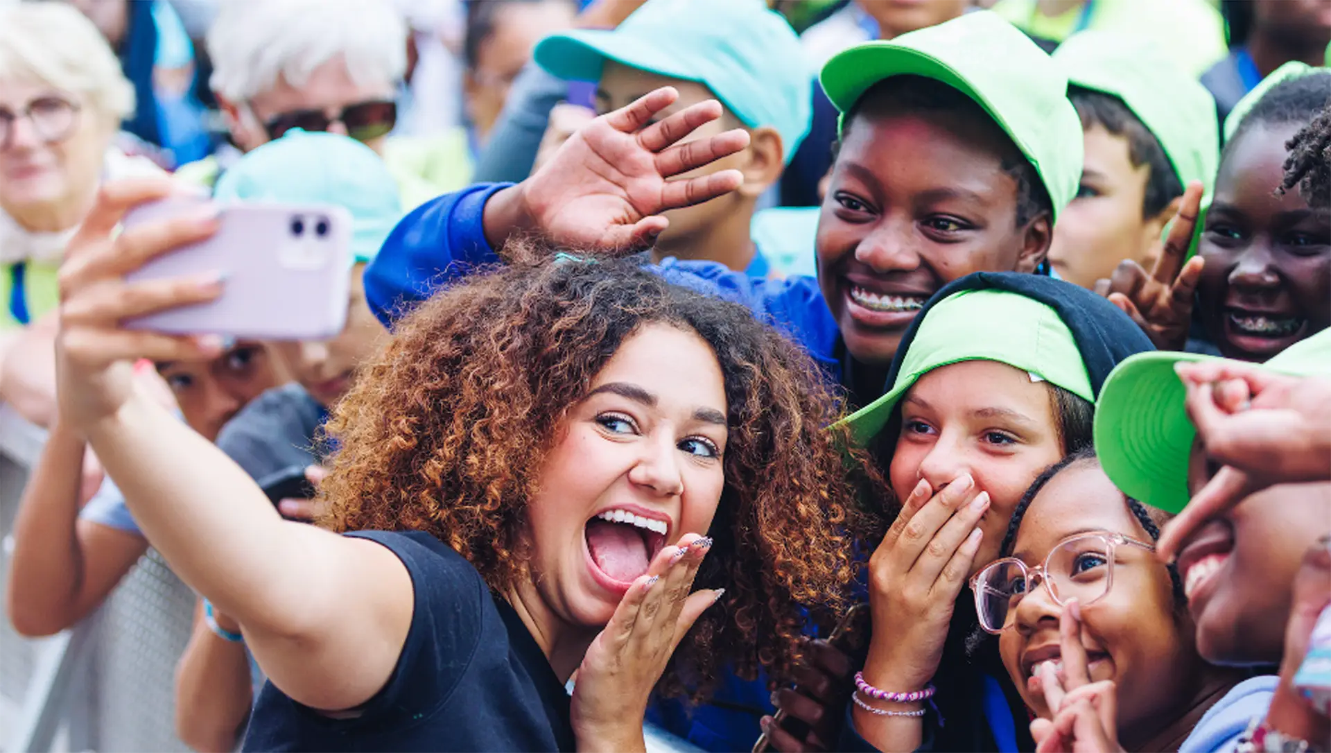 Lena Situations talking a selfie with children in the crowd